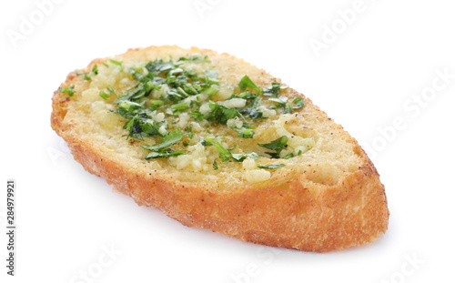 Slice of toasted bread with garlic and herb on white background