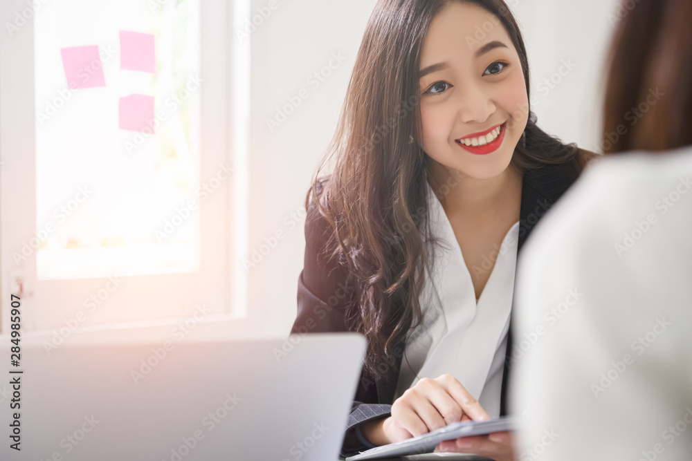 A young attractive asian woman is interviewing for a job. Her interviewers are diverse. Human resources manager conducting job interview with applicants in office A young attractive asian woman is interviewing for a job. Her interviewers are diverse. Human resources manager conducting job interview with applicants in office