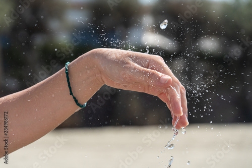 Female hands under running water