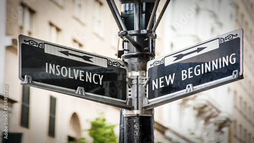 Street Sign to NEW BEGINNING versus INSOLVENCY photo