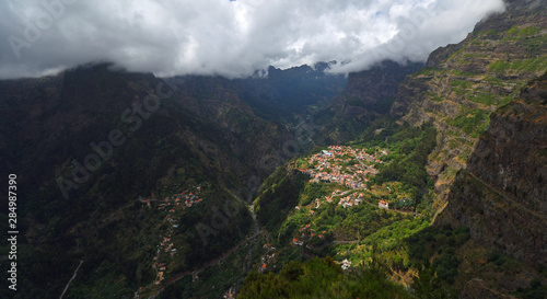 'Nuns Valley' village sites in deep steep sided valley with low clouds Madeira Portugal. 