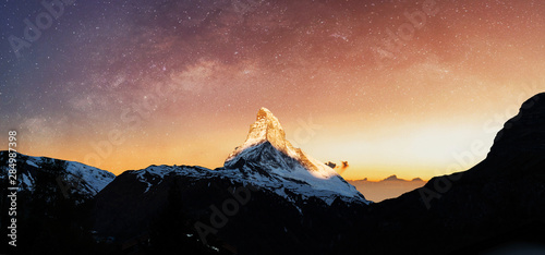 фотография Swiss Alps, Panoramic Matterhorn mountain in sunrise with starry sky in dawn