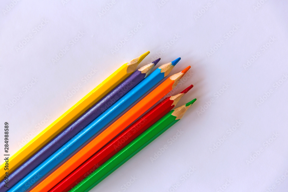 Fototapeta premium Colour pencils on white background. Сlose up. Copy space.