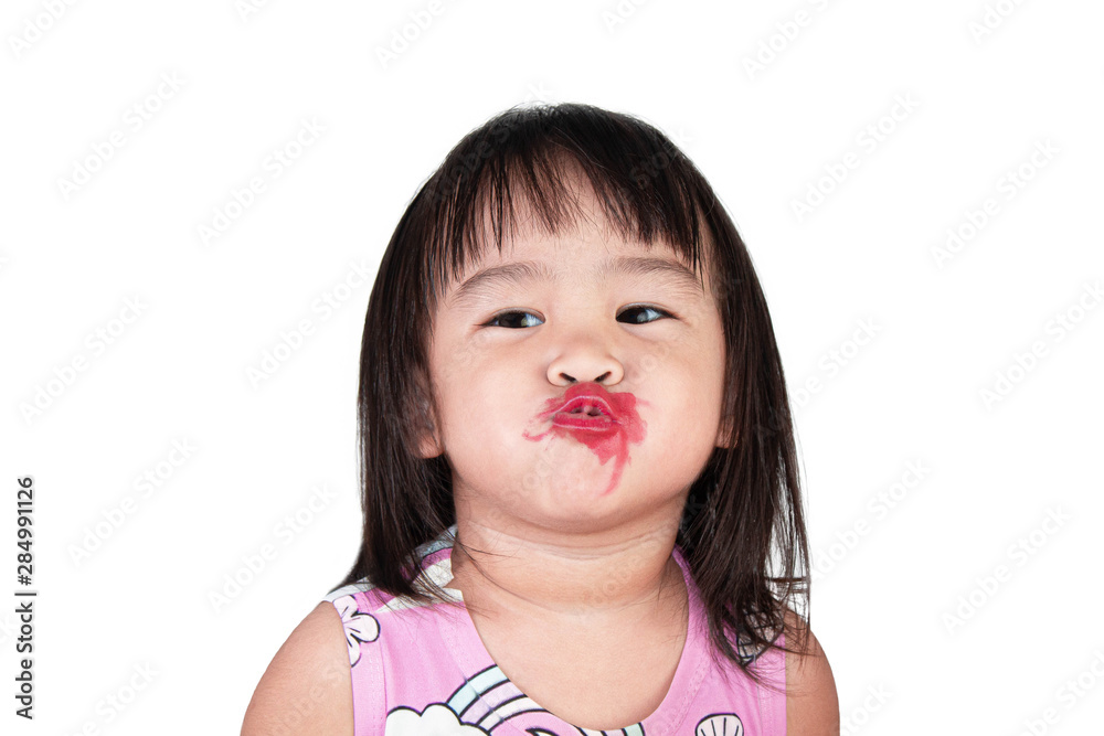 Happy Asian child girl with apply red lipstick wearing pink dress isolated on white background. Happy Asian child girl with apply red lipstick wearing pink dress isolated on white background.