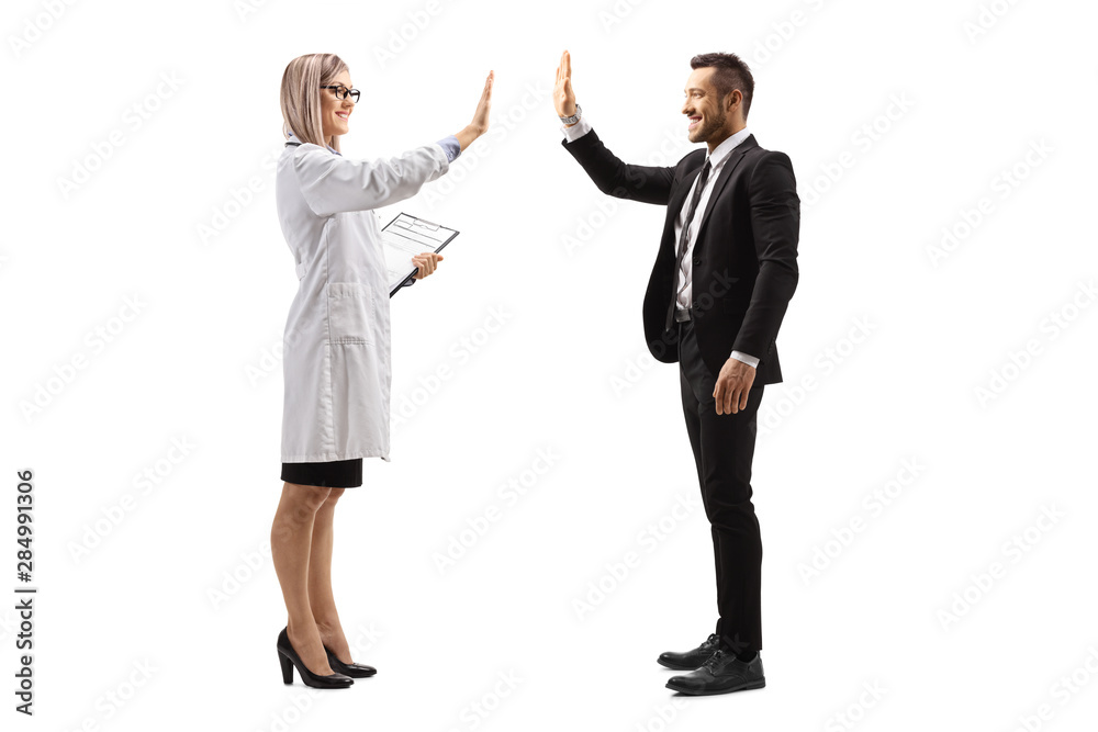 Young female doctor making high-five gesture with a businessman Young female doctor making high-five gesture with a businessman