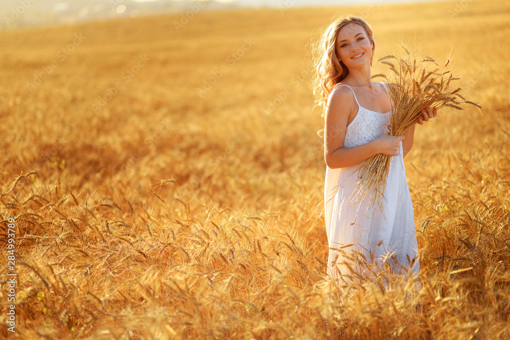 Beautiful young woman in wheat field at sunset outdoor . Beautiful young woman in wheat field at sunset outdoor .
