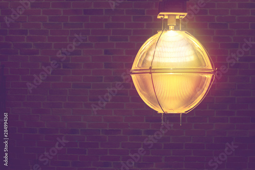 vintage light lamp decorate on dark brick wall background