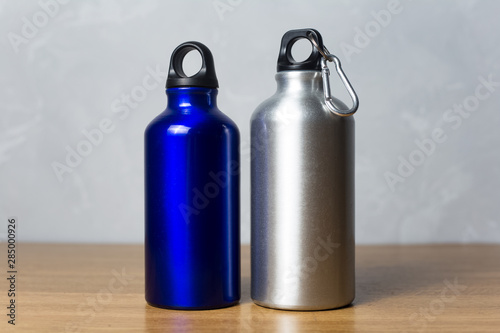 Two miscellaneous thermo bottle on the wooden table