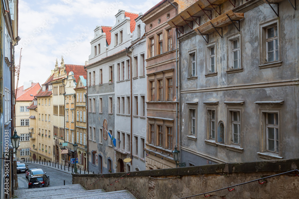Fototapeta premium Empty stairs to the Prague Castle and old buildings along the Thunovska street at the Mala Strana (Lesser Town) district in Prague, Czech Republic.