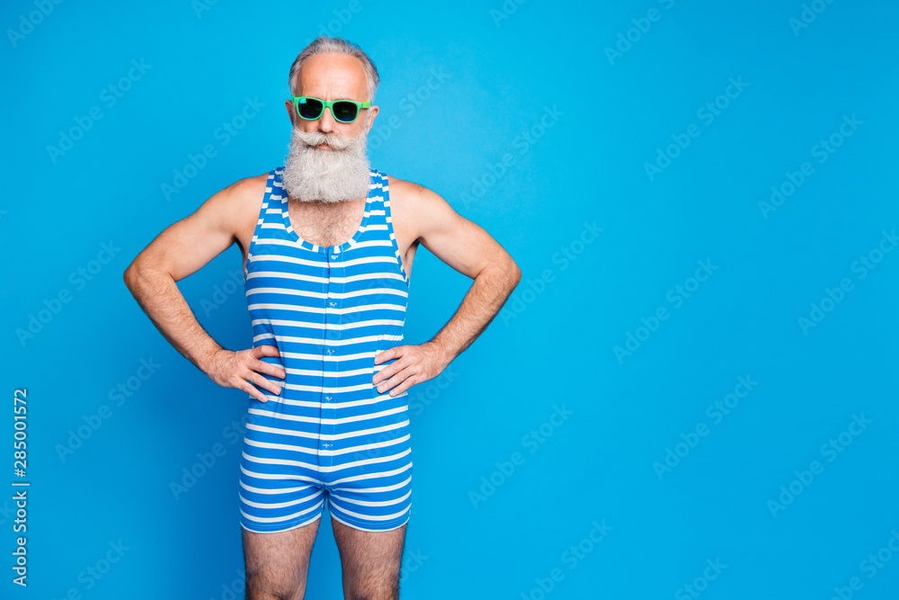 Portrait of his he nice attractive content gray-haired man hipster hands on hips summertime tour isolated over bright vivid shine turquoise blue green background Portrait of his he nice attractive content gray-haired man hipster hands on hips summertime tour isolated over bright vivid shine turquoise blue green background