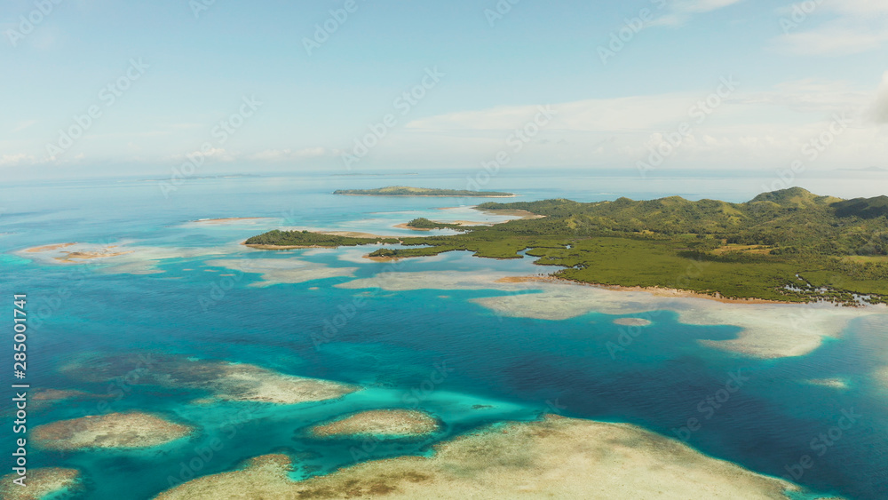 Seascape: Tropical Islands with beaches and azure coral reef water from above. Bucas grande, Philippines. Summer and travel vacation concept.