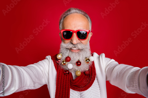 Close up photo of cheerful hipster in eyeglasses eyewear make photo have collection of decorative balls wear white jumper isolated over red background © deagreez