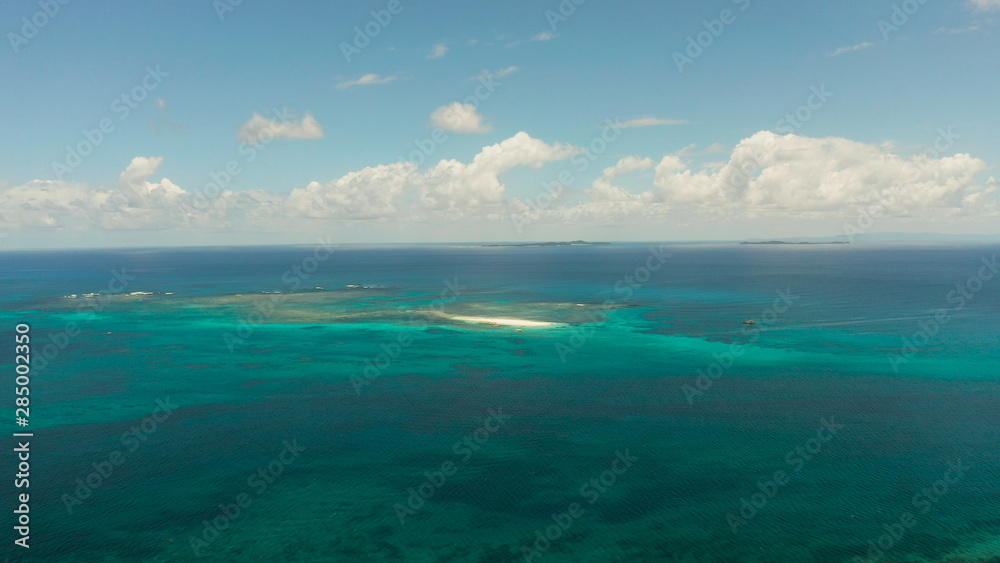 Blue sea with atoll and coral reef, islands under the sky with clouds, top view. Summer and travel vacation concept. Siargao,Philippines. Blue sea with atoll and coral reef, islands under the sky with clouds, top view. Summer and travel vacation concept. Siargao,Philippines.