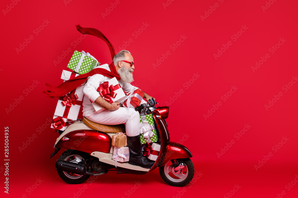 Profile side view of his he nice attractive trendy purposeful gray-haired man riding moto bike delivering pile stack purchase air wind blows isolated on bright vivid shine red background - obrazy, fototapety, plakaty 