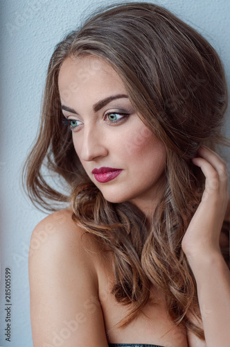 Face of a beautiful young girl with a clean fresh face close up.Brunette women with green eyses,red lips.
