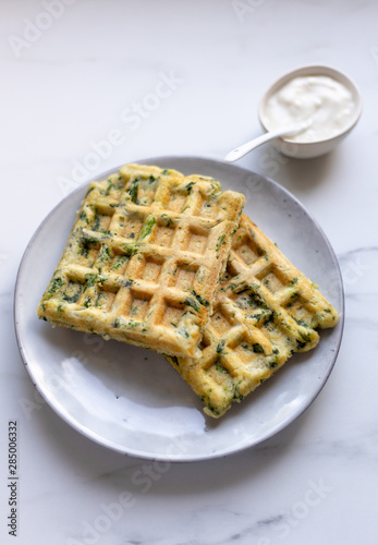 spinach waffles on white marble background with opy space