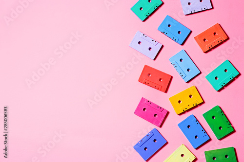 Painted audio cassettes on pastel pink background  copy space  top view. Retro musical background