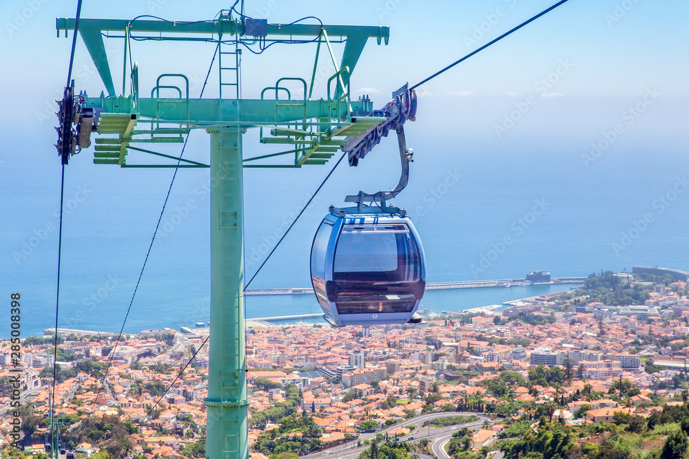 Cable car with cabins above city and sea in Portugal