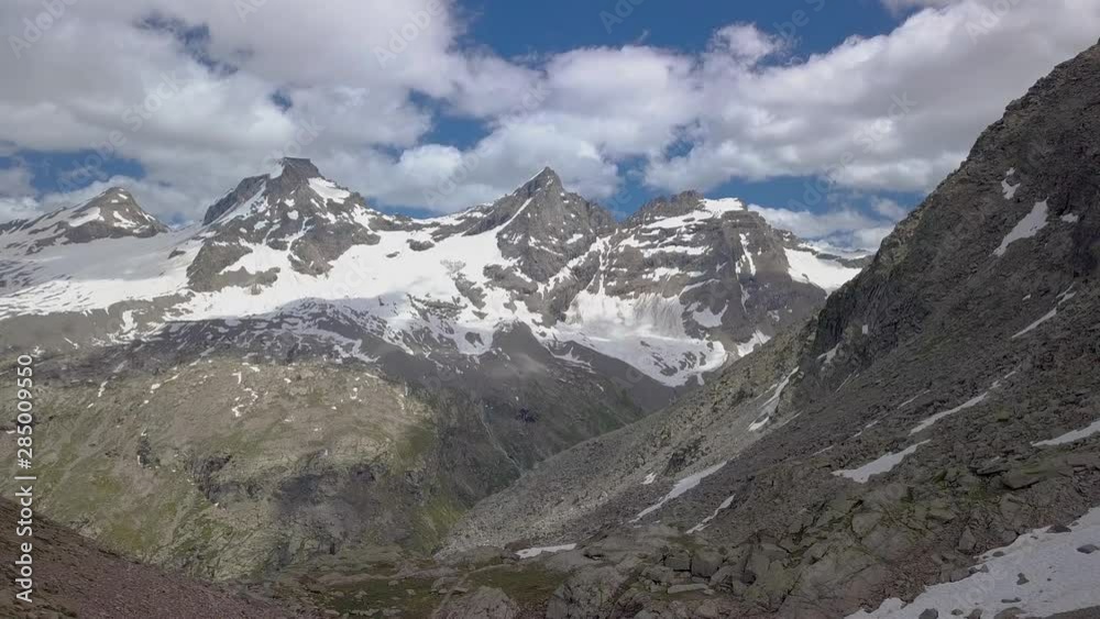 Aerial Flight over group of tourists traveling in the Alps. Grand Paradiso in the Italian Alps. 4K Aerial Flight over group of tourists traveling in the Alps. Grand Paradiso in the Italian Alps. 4K
