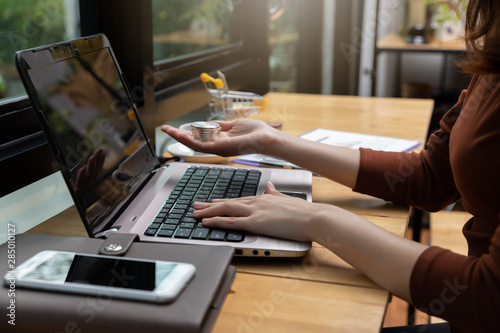 Freelancer business woman holding credit cart to shopping online with computer laptop in cafe.