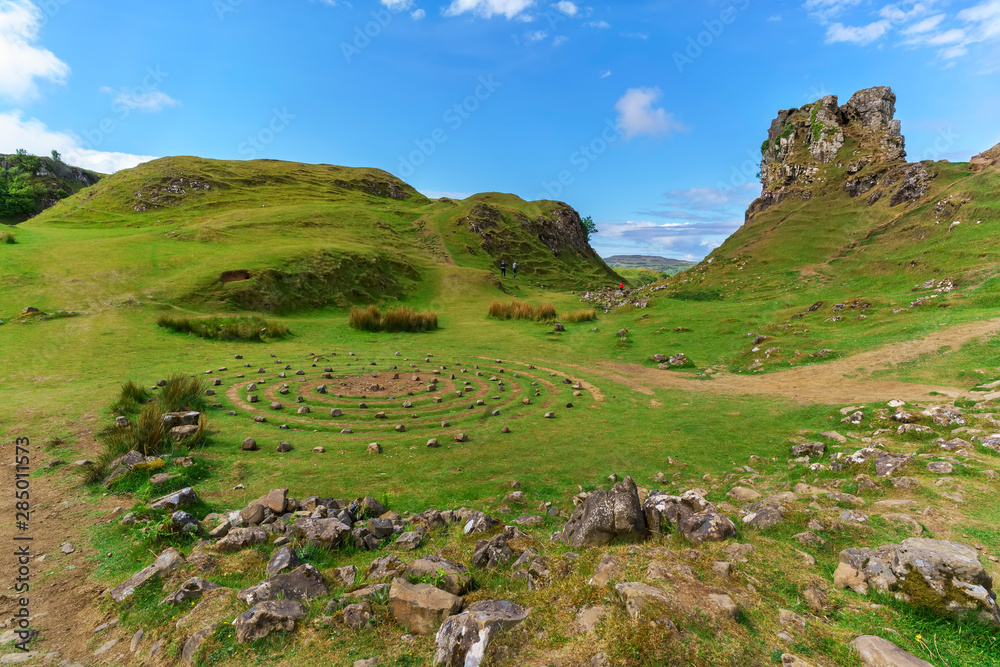 Obraz premium The Fairy Glen and Castle Ewen , The stone circle and landscape of grassy, cone-shaped hills in summer , Uig , Scotland