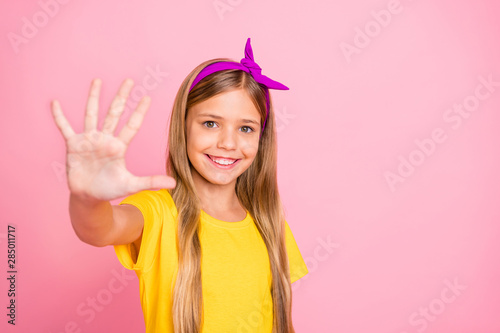 Close-up portrait of her she nice attractive pretty winsome cheerful cheery optimistic pre-teen girl wearing yellow t-shirt diligent work done isolated over pink pastel background