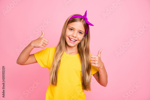 Photo of kind nice cute friendly girl showing you thumb up to give you nice feedback while isolated with pink background