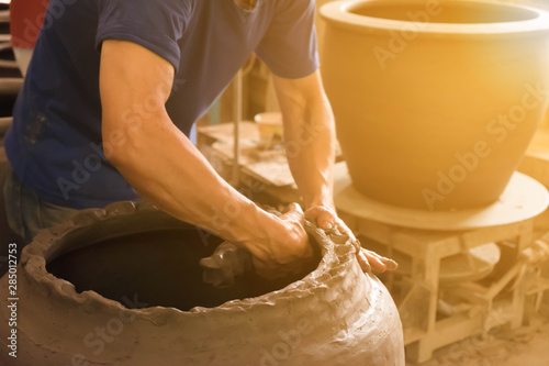 The artisans are creating jobs. large pots are pottery products. The clay became a ceramic. It is a workmanship that is elaborate and detailed. Beautiful sculptures and art. photo