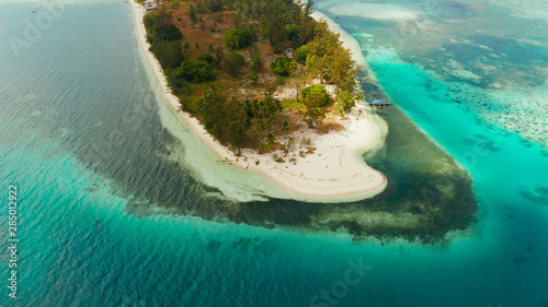 Sandy beach and tropical island by atoll with coral reef and azure water, top view. Canabungan Island with sandy beach. Summer and travel vacation concept.