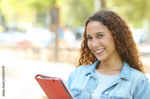 Happy mixed race student posing looking at camera