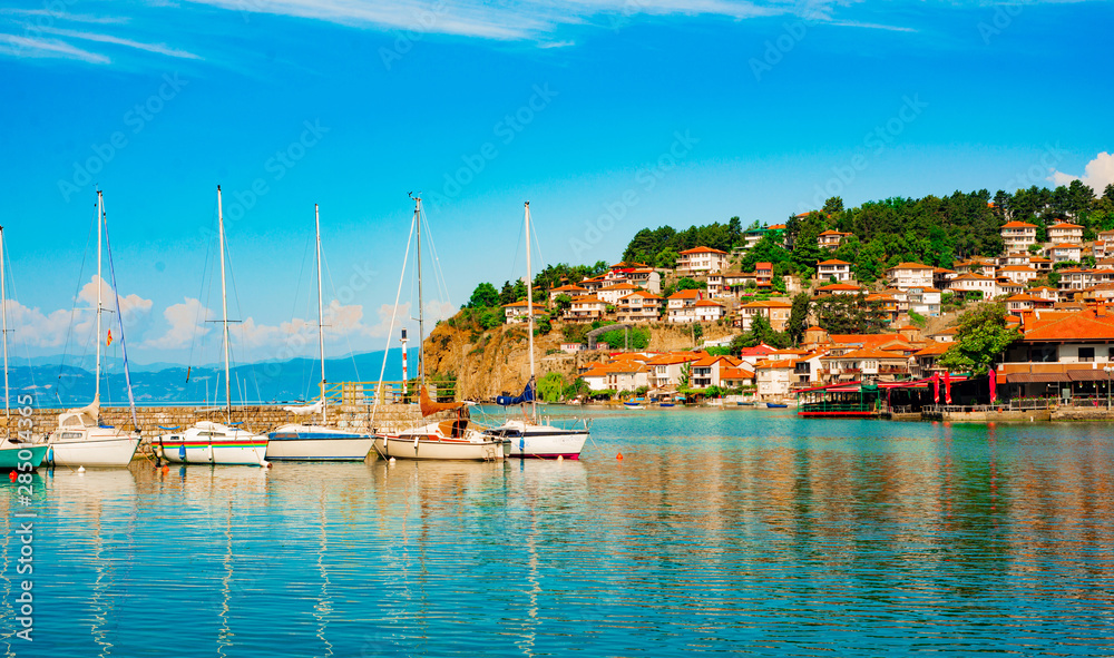 North macedonia. Ohrid. Pier with different sailboats and hill with buildings