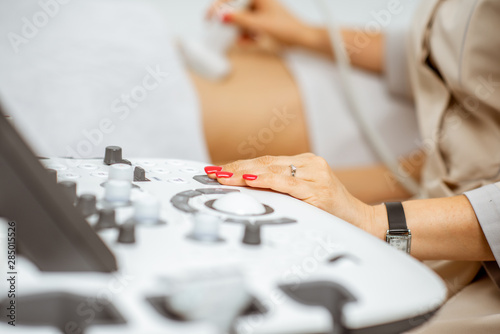 Doctor performs ultrasound examination of a woman