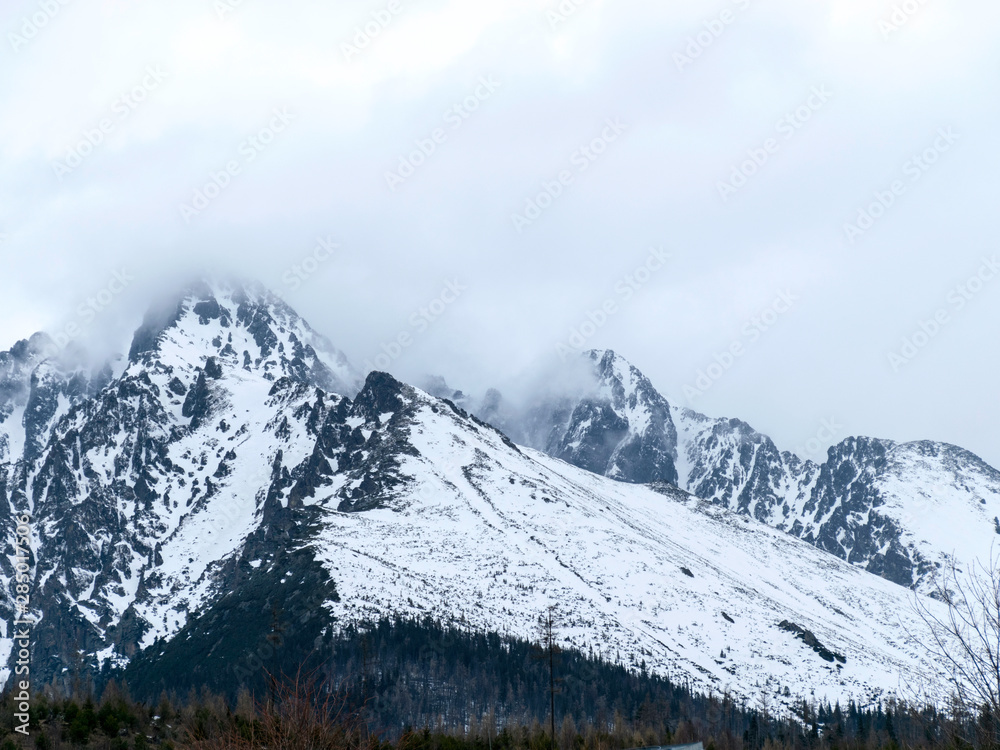 mountains and rocks covered with snow, overcast winter day, Tatras, Slovakia