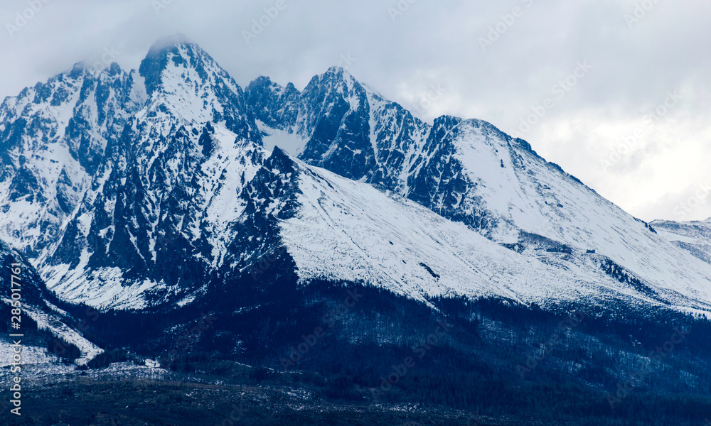 mountains and rocks covered with snow, overcast winter day, Tatras, Slovakia