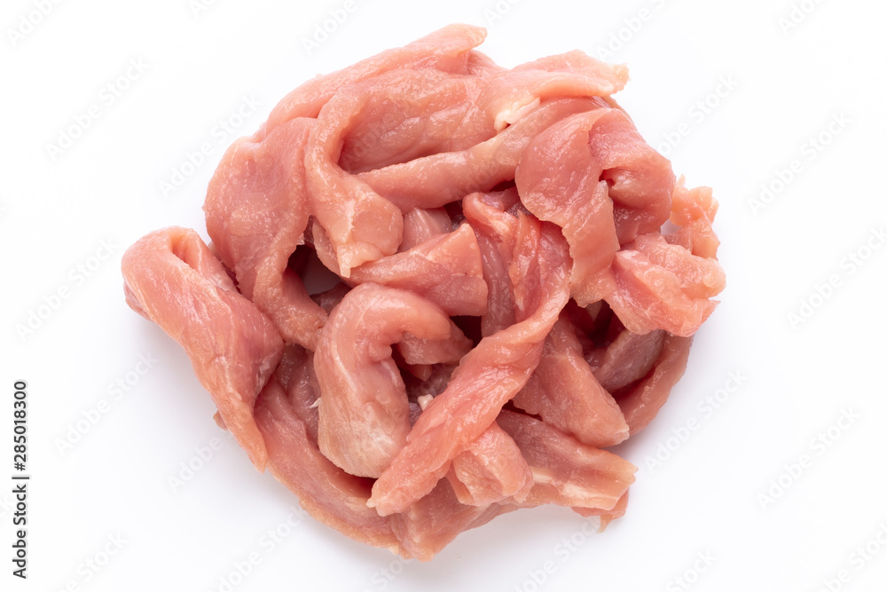 Raw chicken fillet. Small pieces of meat isolated on white.