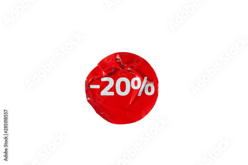 Red round crumpled sticky sticker with 20 discount on isolated white background.