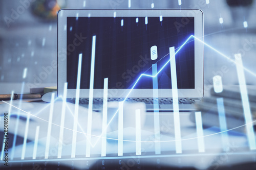 Stock market graph and table with computer background. Double exposure. Concept of financial analysis. © peshkova