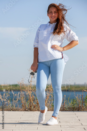 Full length portrait of a beautiful woman in blue jeans