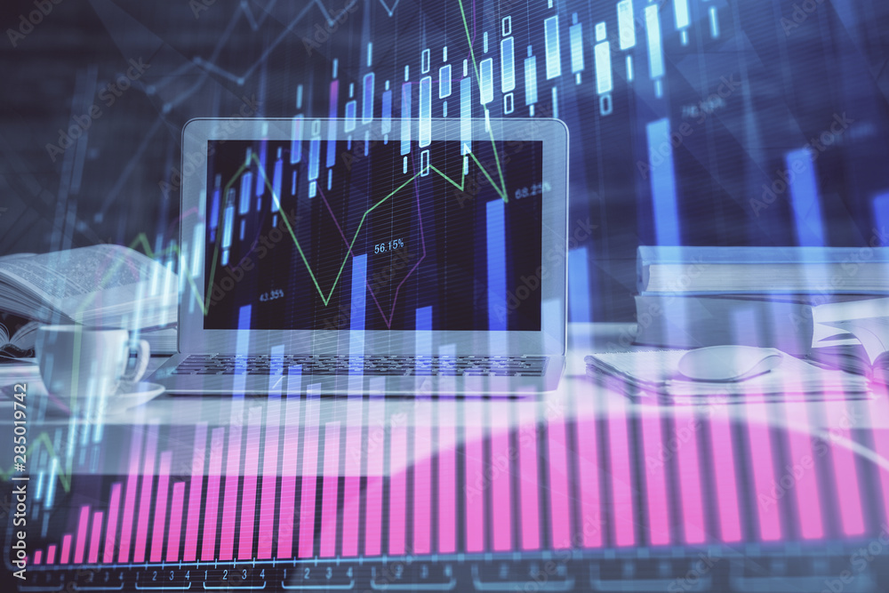 Forex market graph hologram and personal computer on background. Multi exposure. Concept of investment. Forex market graph hologram and personal computer on background. Multi exposure. Concept of investment.
