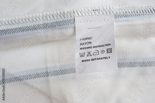 White laundry care washing instructions clothes label on rayon shirt photo