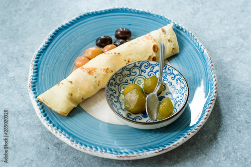 Plain Wrapped Crepe with Fig Jam, and Olives for Breakfast photo