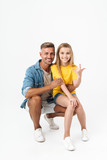 Full length photo of happy caucasian family father and daughter smiling and showing sign of horns