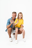 Full length photo of beautiful caucasian family father and daughter smiling and showing ok sign