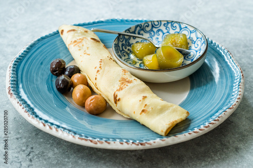 Plain Wrapped Crepe with Fig Jam, and Olives for Breakfast photo