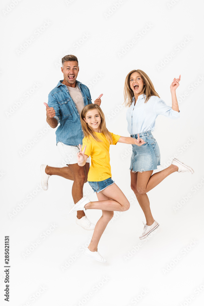 Full length photo of joyous caucasian family woman and man with little girl smiling and having fun together Full length photo of joyous caucasian family woman and man with little girl smiling and having fun together