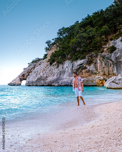 young men walking on the ebach during vacation Orosei coast Sardinia Italy photo