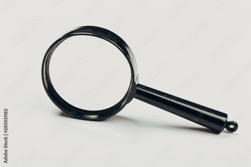 Small magnifying glass on light background, search