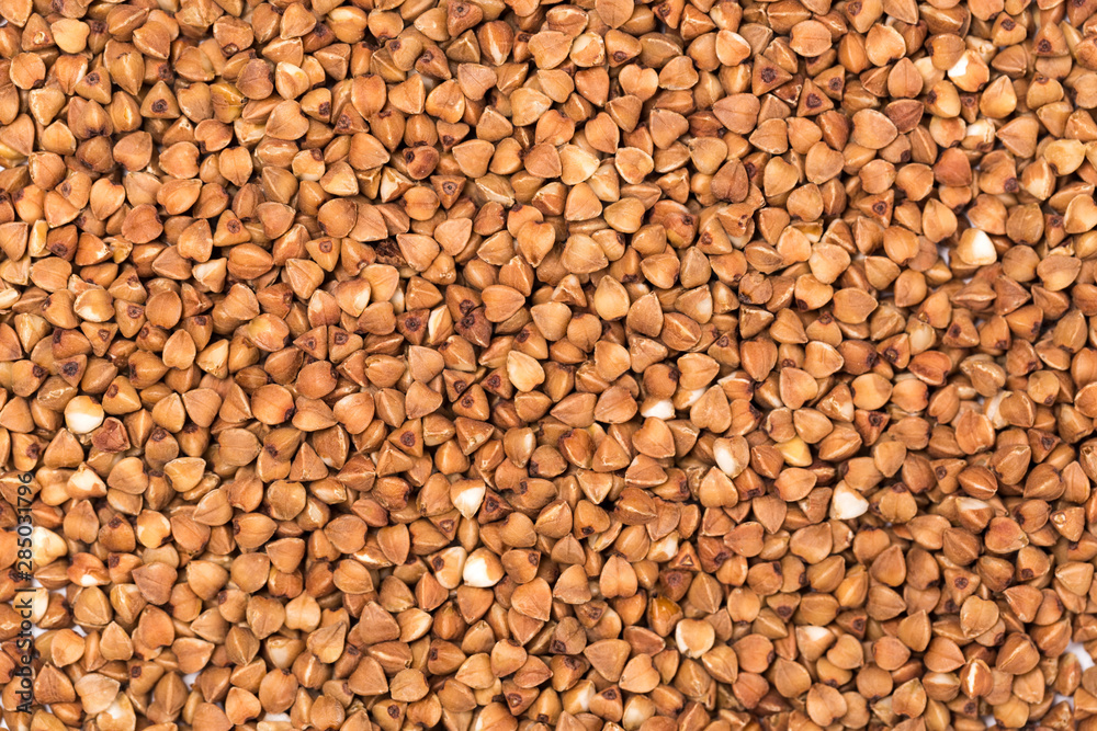 Macro Photo food buckwheat groats. Texture background grain buckwheat groats. Image food product porridge buckwheat grains Macro Photo food buckwheat groats. Texture background grain buckwheat groats. Image food product porridge buckwheat grains