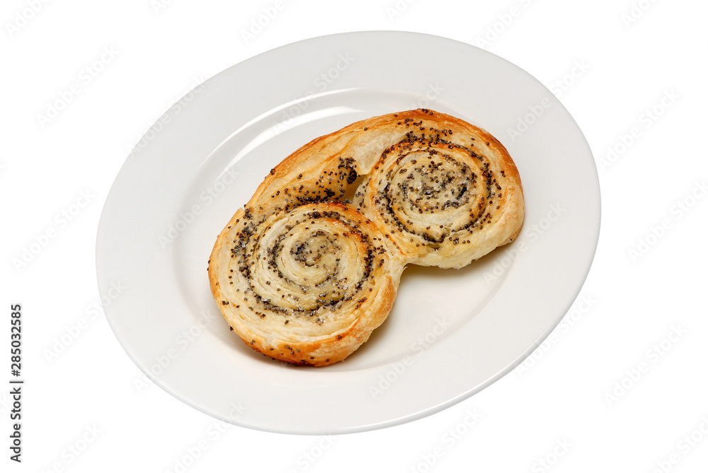 Sweet layered baked buns with poppy seeds and honey filling inside. Dessert pastry on plate isolated on white.