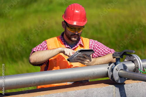 Monitor procces of filtering water, holding tablet